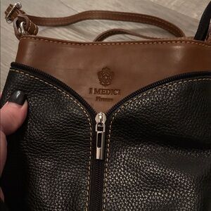 I Medici Firenze black and brown leather crossbody bag with a zip closure